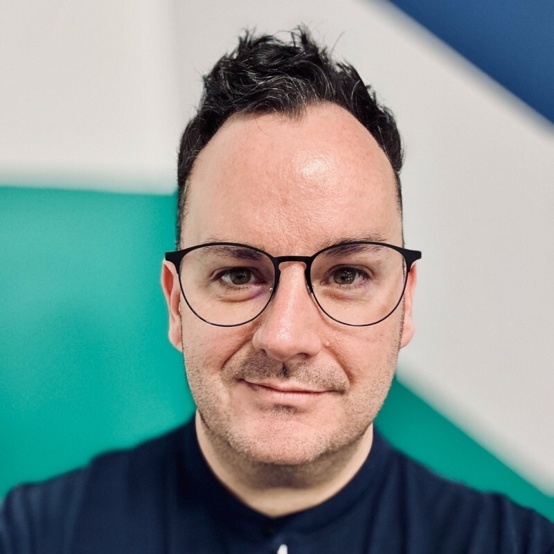 Image is of Scottish Autism Business Ambassador Ian Moffat-Kyle wearing glasses and smiling for the camera